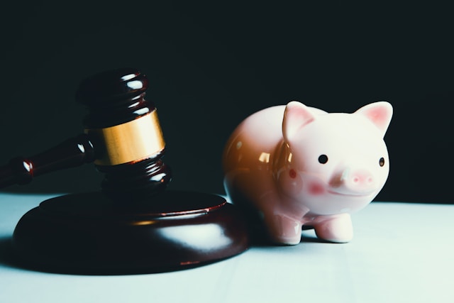 pink piggy bank next to gavel